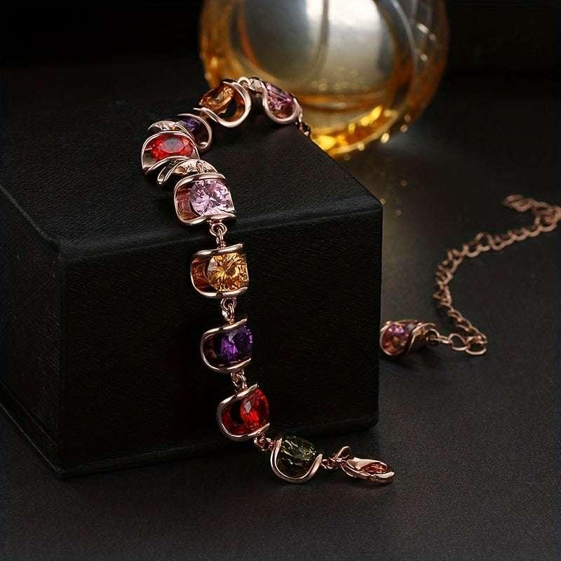 Elegant multicolor gemstone bracelet with rose gold links, displayed on black box with matching necklace